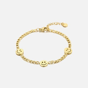 Schakelarmband smiley faces goud