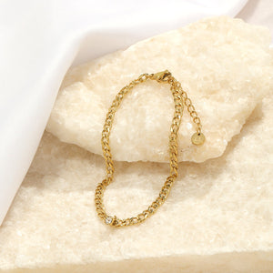 Schakelarmband steentje goud